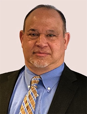 Photo of David A. Bergantino in a dark suit with blue shirt and patterned tie